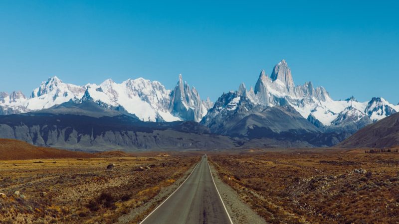 Aerial view of the highway to the dramatic mountain range with Fitz Roy mountain in the middle  - a road to El Chalten, Argentina